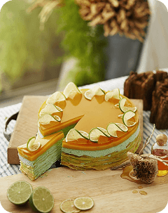 Round caramel-colored cake with pale piped decorations and one slice removed.